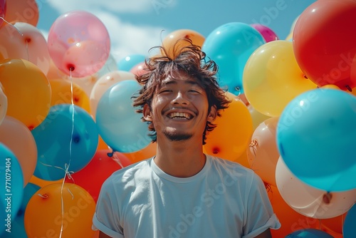 Asian man with balloons.