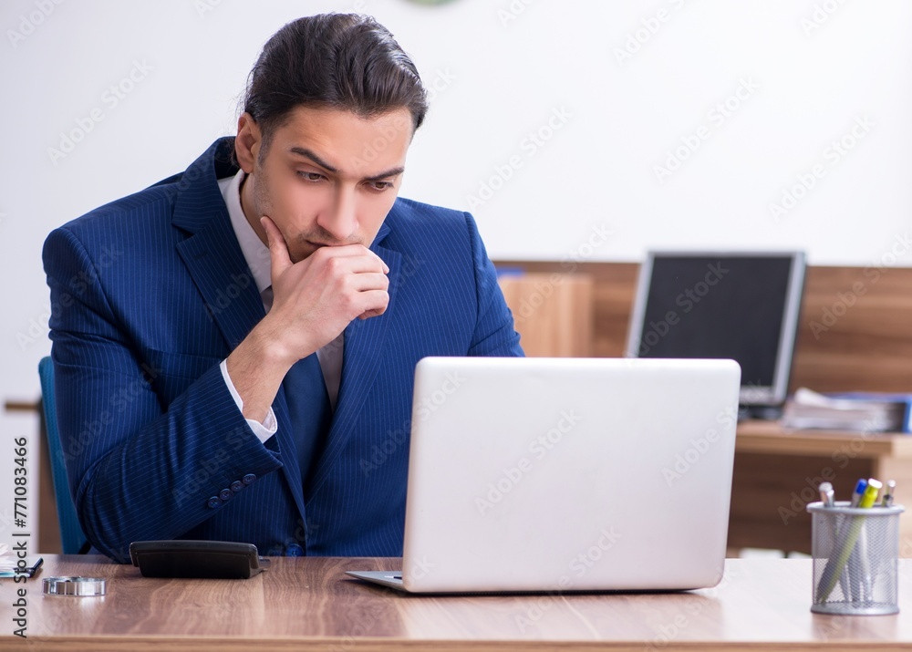 Young male businessman working in the office Young male businessman working in the office