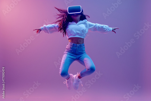 A online health game. Young woman wearing virtual reality headset to exercise while jumping into the air as a metaverse avatar against a purple studio background.