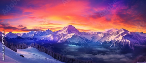 A picturesque natural landscape with a snowy mountain range painted against a colorful sunset sky. The geological phenomenon creates a breathtaking horizon photo