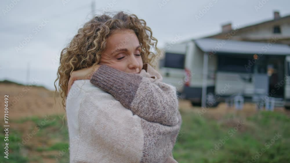 Peaceful lady enjoy cloudy nature standing near modern campervan alone closeup. Peaceful lady enjoy cloudy nature standing near modern campervan alone closeup.