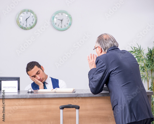 Old businessman at the hotel reception