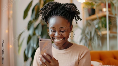 Smiling African American woman using smartphone at home with cozy interior in the background. photo