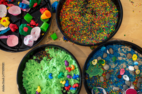 Photography Sensory play bins, each filled with different colorful materials to stimulate the senses