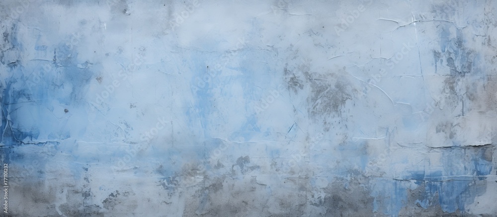 Fototapeta premium A close up of a freezing grey concrete wall resembling a geological phenomenon in winter. The sky above is painted with electric blue and cumulus clouds, enhancing the natural landscape