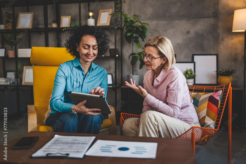 two women work on project at home use digital tablet have consultation