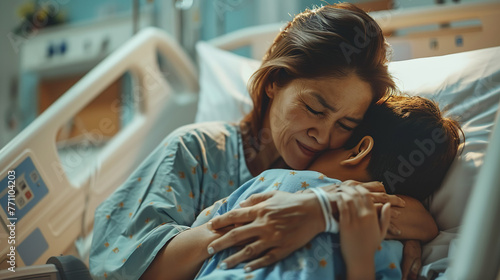 Mother comforts sick son at hospital son who is recuperating and hugged his mother with love, giving her warmth in the hospital.