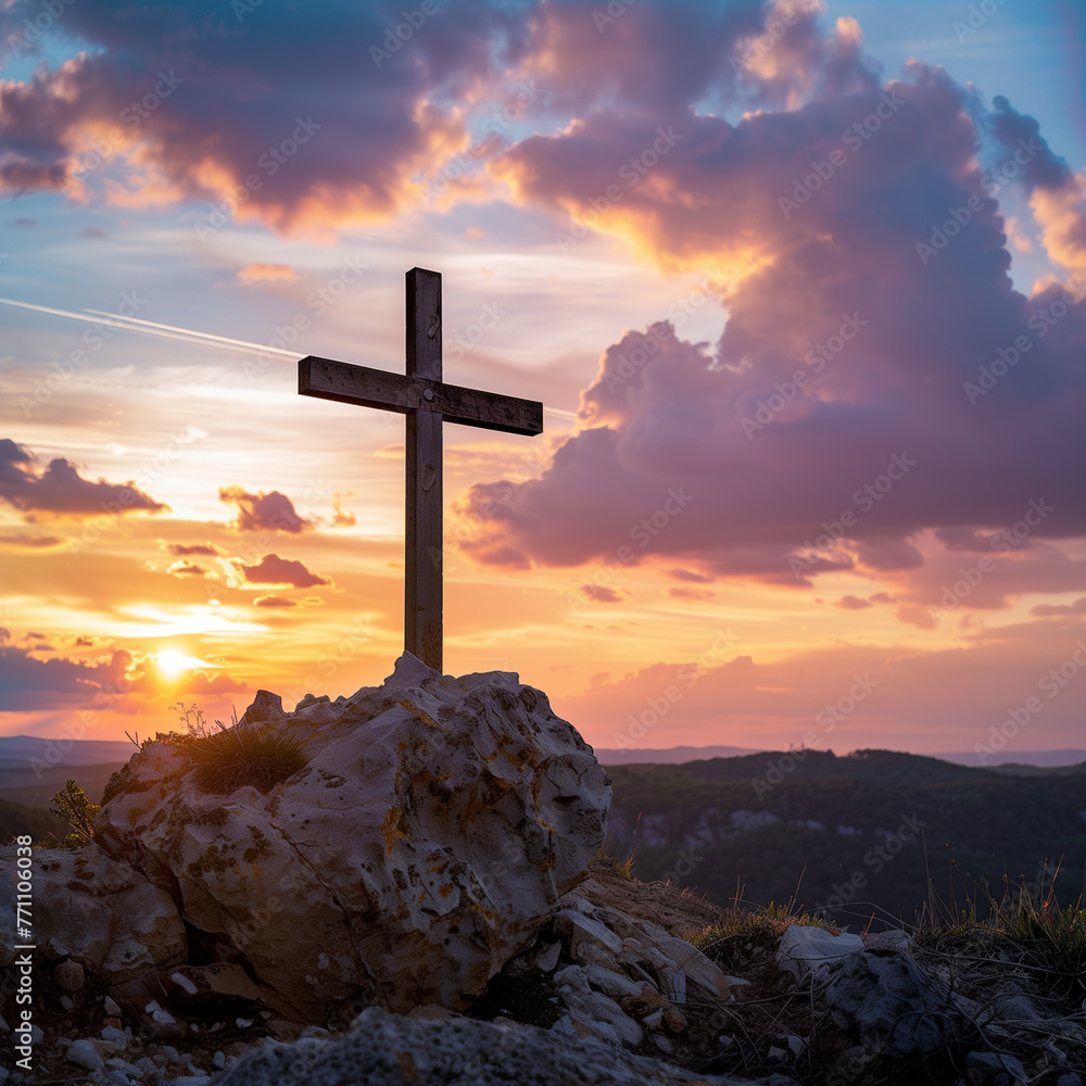 Cross on the rock in front of the sunset. The concept of faith, spirituality and religion.