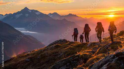 A serene scene of hikers on a mountain ridge with the warm glow of sunrise in the background © Daniel