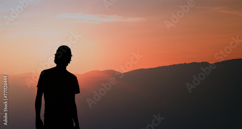 Silhouette of a young man standing at sunset © HalilKorkmazer