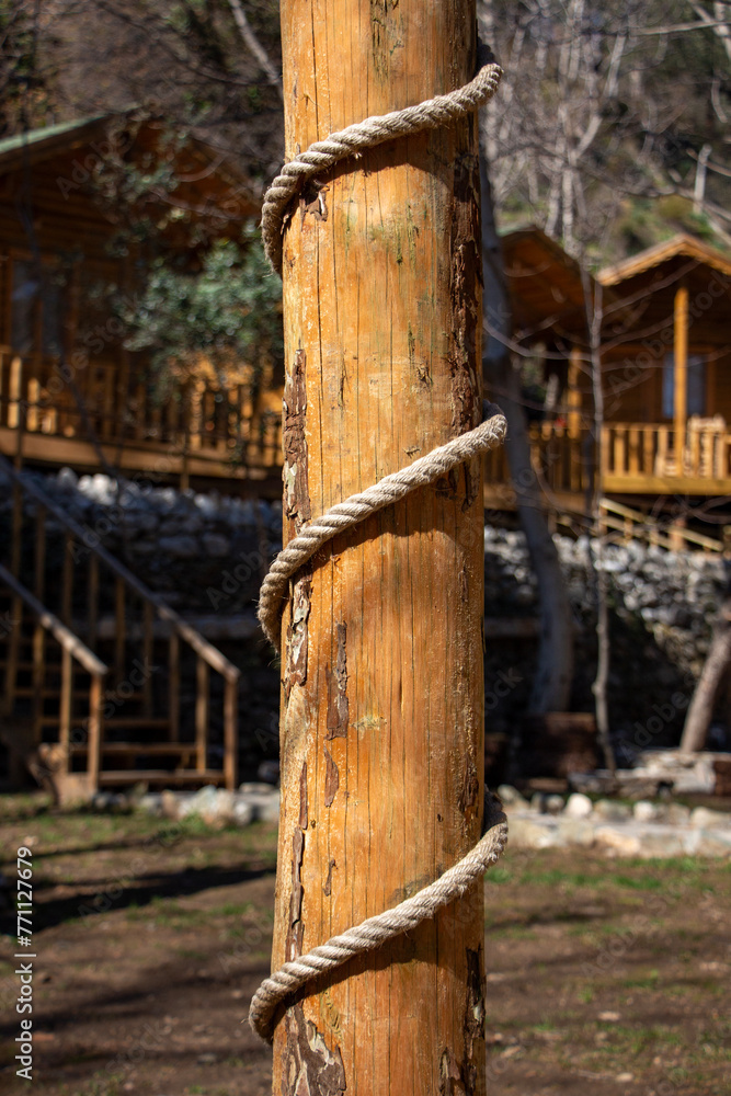 Fototapeta premium Rope tied to a wooden pole in the courtyard of the house