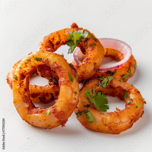 Indian street style onion rings and veggies frying in sizzling oil captured in side view