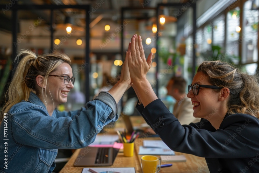 Successful business people giving each other a high five in a meeting ...
