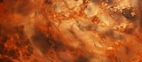 A close up of a wood fire with amber flames and smoke swirling into the peachcolored sky, creating a mesmerizing pattern of heat and art in the air