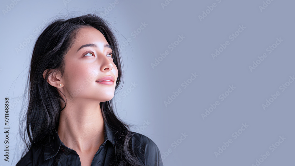 Side view of Malay businesswoman wearing black shirt, smiling candid Side view of Malay businesswoman wearing black shirt, smiling candid
