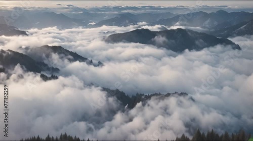 Aerial view over a winter forest mountain range with low clouds covering the scenic landscape
 photo