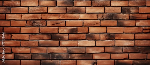A closeup shot of a brown brick wall showcasing the building materials rectangular shape, symmetry, and pattern created by the mortar in between the bricks
