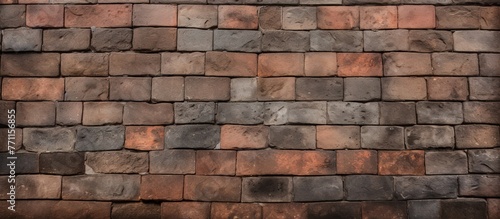 A detailed closeup of a brown brick wall with shingles, showcasing the intricate brickwork and composite materials used in the building facade