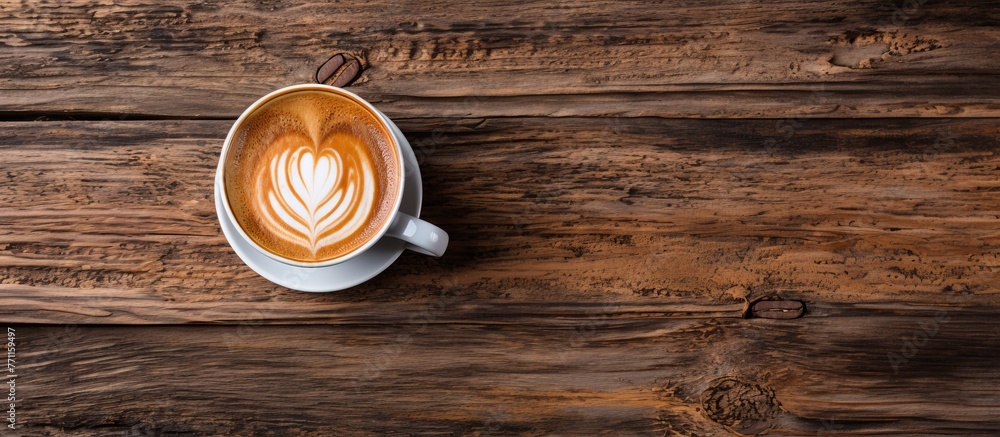 A cappuccino sits on a brown wooden table, adorned with heartshaped latte art. The hardwood surface enhances the warm ambiance of the drink A cappuccino sits on a brown wooden table, adorned with heartshaped latte art. The hardwood surface enhances the warm ambiance of the drink
