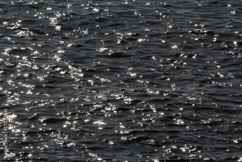 Sunlight reflecting off of the surface of ocean ripples water