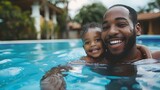 Portrait of happy father and toddler son in swimming pool
