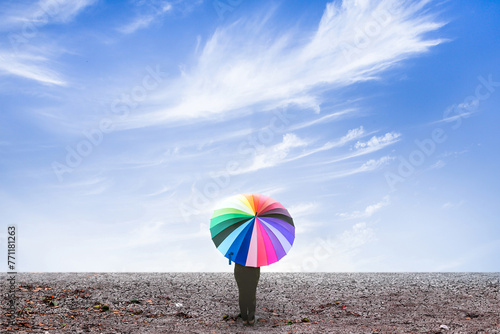 lonely woman holding umbrella standing on dry ground with blue sky cloudy. umbrella standing on dry ground.