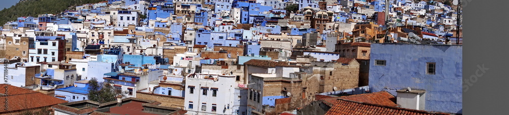 Panoramam of blue and white houses in a hill in the medina, in Chefchaouen, Morocco