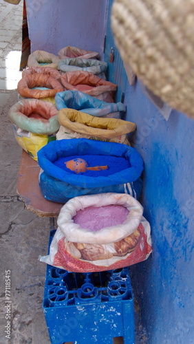 Sacks of powdered dyes on a bench in front of a shop in Chefchaouen, Morocco © Angela