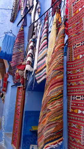 Colorful textiles on display in Chefchaouen, Morocco © Angela