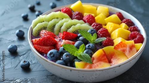 A vibrant acai bowl garnished with a rainbow of fresh fruits