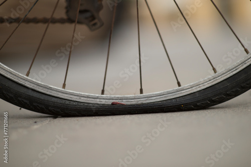 Fototapeta Naklejka Na Ścianę i Meble -  close up of bicycle wheels, flat tire, bicycle, downtown streets, Alghero. Sardinia, Italy