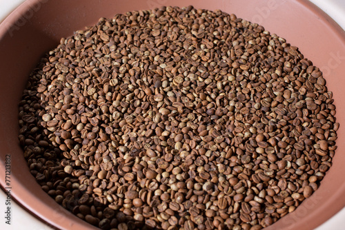 A view of a pile of light roasted coffee beans.