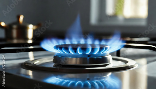 Blue flame of a gas burner on a gas stove in the kitchen