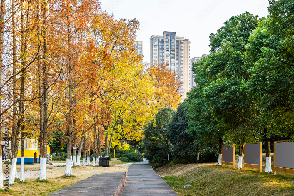 Modern urban scenery in autumn, with towering buildings in the distance and lush vegetation in nearby parks Modern urban scenery in autumn, with towering buildings in the distance and lush vegetation in nearby parks