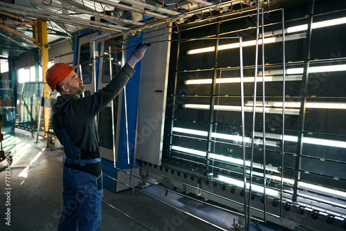 Master glues spacer frames at a window factory photo