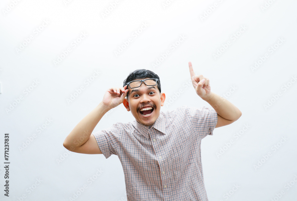 Fototapeta premium an asian man smiles and points to something with his hand