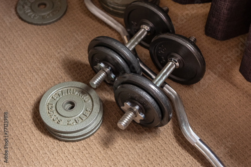 Old used gym weights. Close up on worn dumbbell, fitness equipment in run down gymnasium
