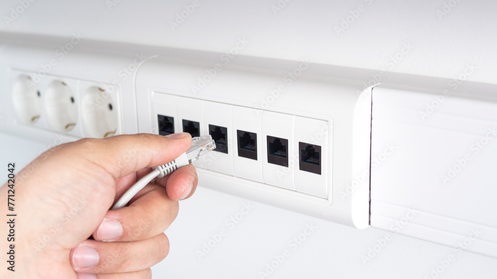 Connecting wires in electrical and lan sockets. Connecting and disconnecting computers in the office local network Connecting wires in electrical and lan sockets. Connecting and disconnecting computers in the office local network