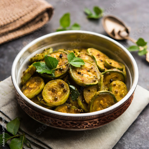 tendli / kundroo sabzi or kovakkai poriyal also known as ivy gourd, served in a bowl or karahi photo