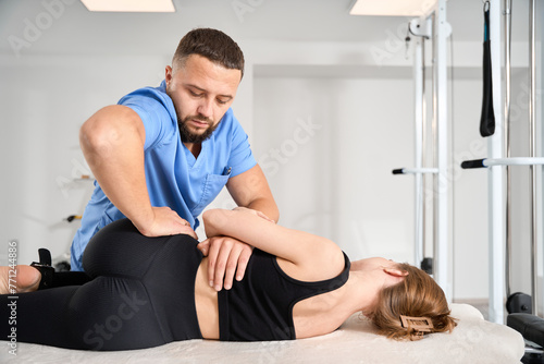 Chiropractor working on young woman spine