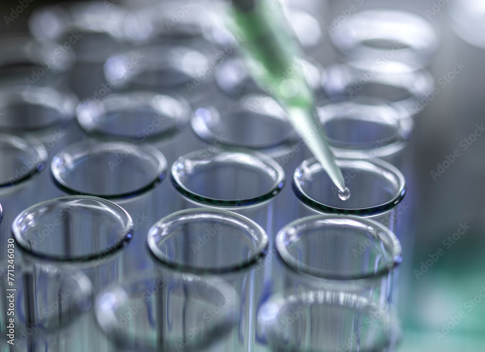 Biotechnology, Pipetting samples into test tubes for analysis Biotechnology, Pipetting samples into test tubes for analysis