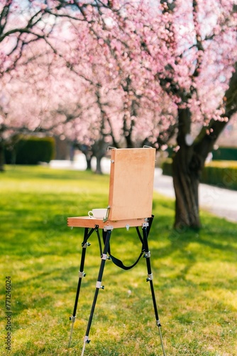 Easel standing in a blooming rose garden in Prague photo