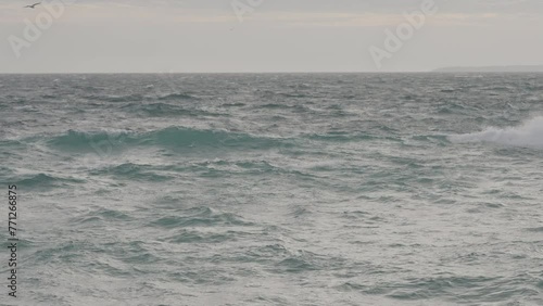 Slow motion shaky shot of stormy Mediterranean sea with strong wind photo