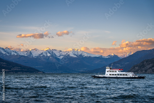 Ferry on Lake Como, Italy with snow covered mountains in the background