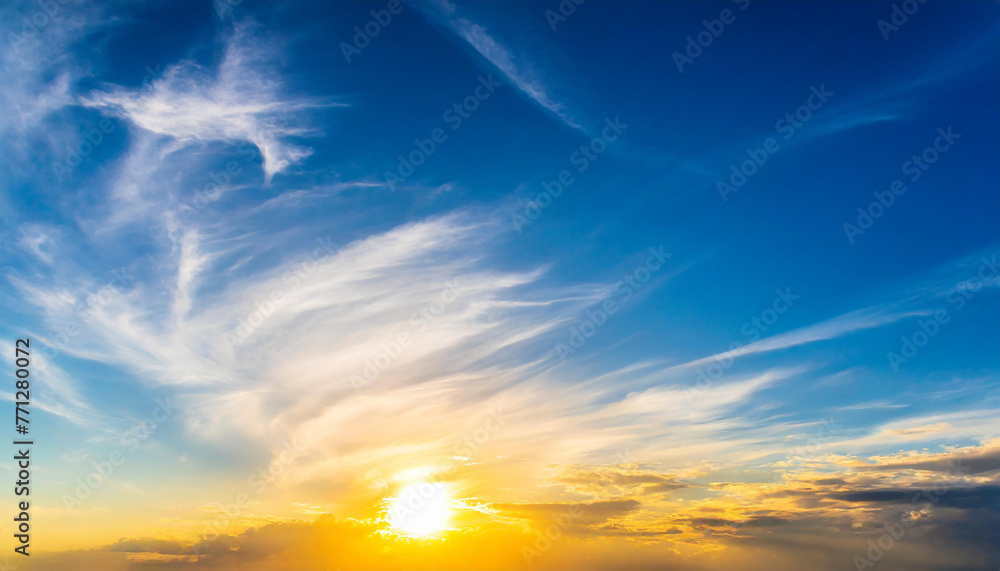 Beautiful blue summer sky with bright sun at sunset as a background