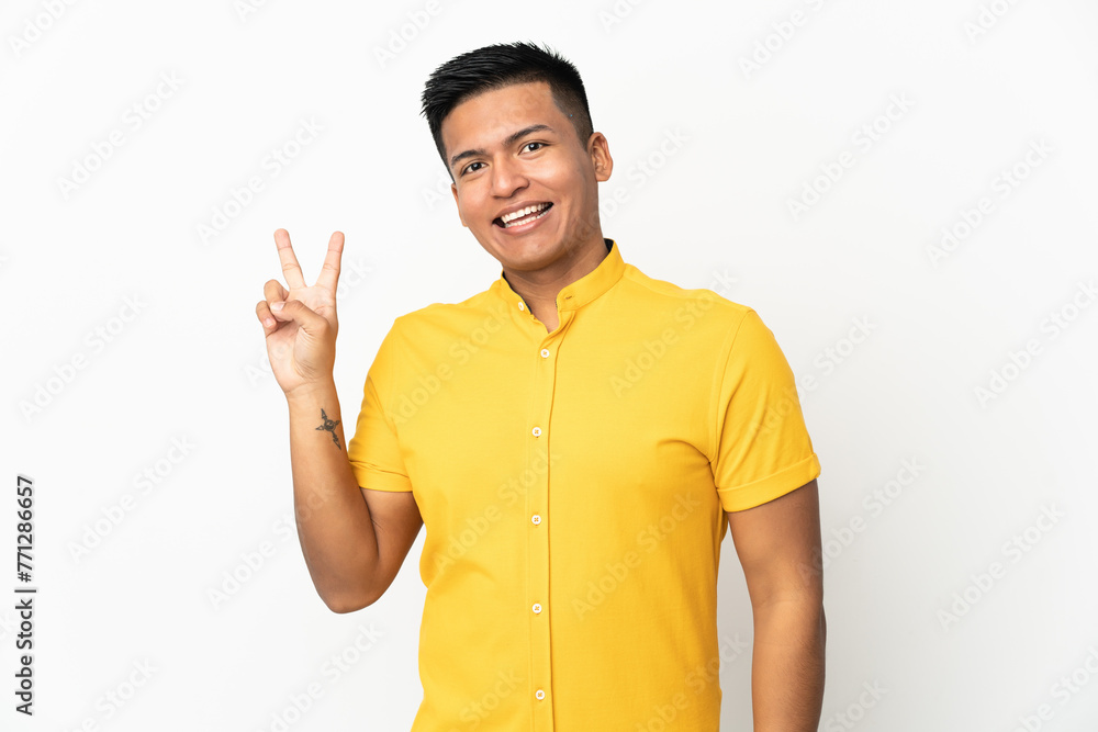 Young Ecuadorian man isolated on white background smiling and showing victory sign Young Ecuadorian man isolated on white background smiling and showing victory sign