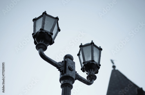 vintage street lamp made of forged metal on the background of the evening sky	
