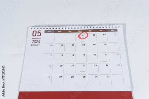 A spiral desk calendar of May page on the white background. 1st May marked or circled as Labour Day. 