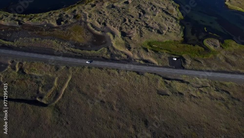 Iceland Drone Shots - 4K. Road 427. Bridge over Hlidarvatn near Reykjanesfolkvangur. Cars driving on vast road. photo