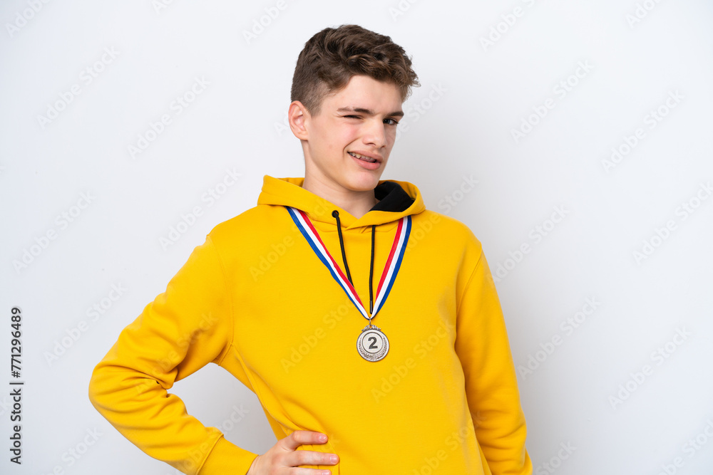 Teenager Russian man with medals isolated on white background suffering from backache for having made an effort Teenager Russian man with medals isolated on white background suffering from backache for having made an effort